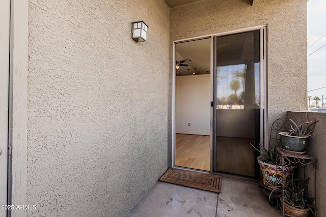 view of exterior entry featuring stucco siding