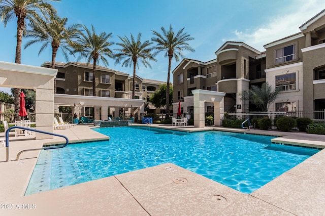 pool featuring a patio and fence