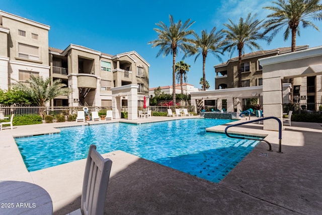 community pool featuring a patio area and fence