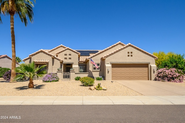 mediterranean / spanish-style home with a garage