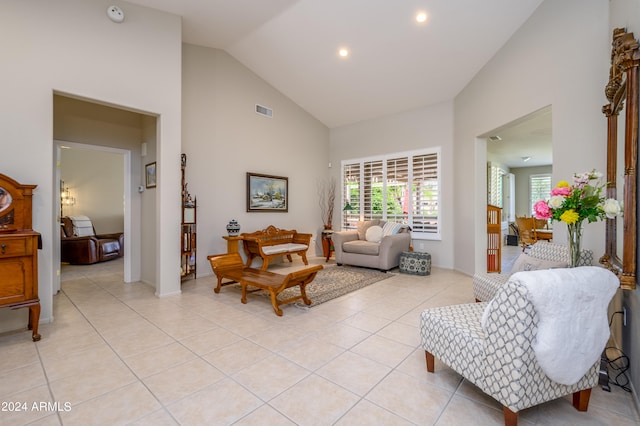 living room with light tile patterned flooring and high vaulted ceiling