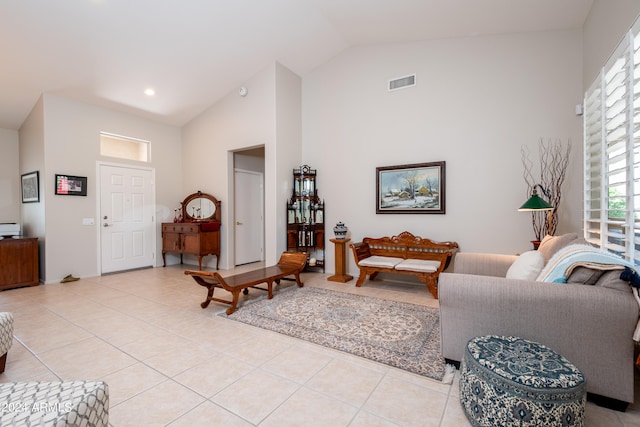 tiled living room featuring high vaulted ceiling