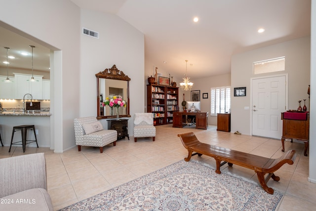 living room featuring an inviting chandelier, high vaulted ceiling, and light tile patterned floors