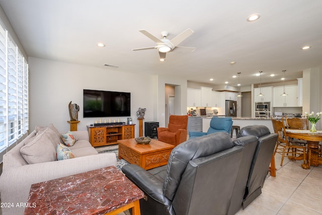 tiled living room with ceiling fan