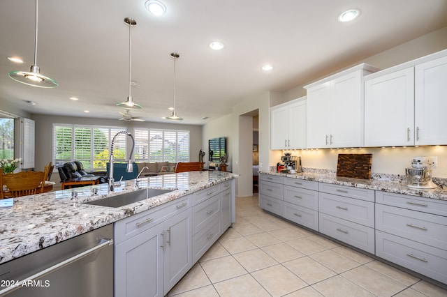 kitchen with hanging light fixtures, ceiling fan, white cabinetry, dishwasher, and sink