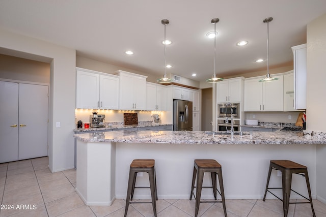 kitchen with light stone counters, stainless steel appliances, and white cabinets