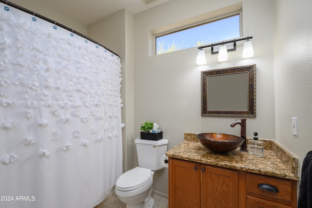 bathroom with vanity, toilet, and tile patterned flooring