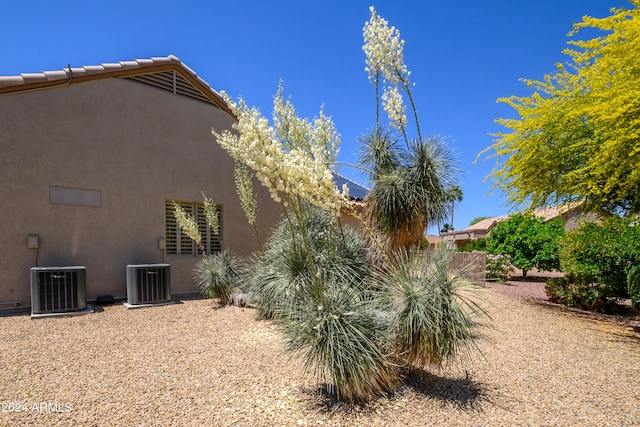 view of side of home featuring central AC unit