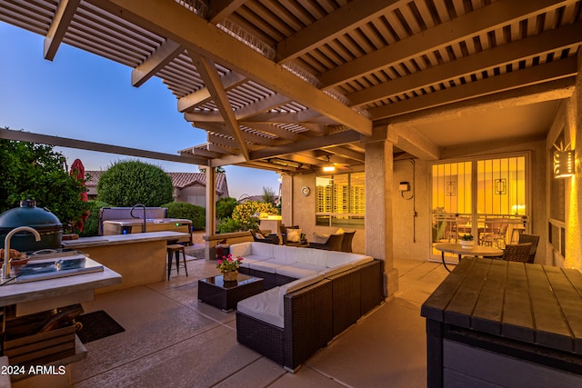 patio terrace at dusk with an outdoor living space, exterior bar, and a pergola