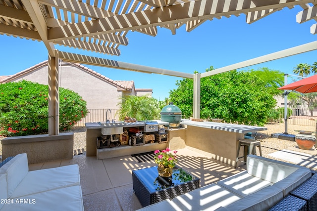 view of patio with area for grilling, sink, grilling area, a pergola, and an outdoor living space