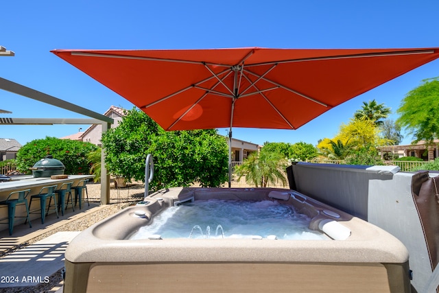 view of swimming pool featuring a hot tub and a bar