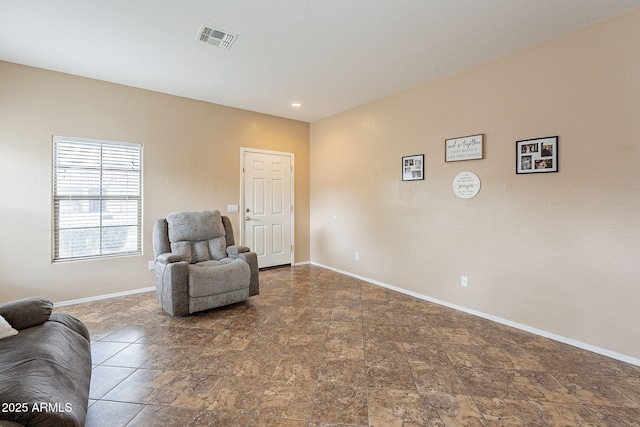 sitting room with visible vents and baseboards