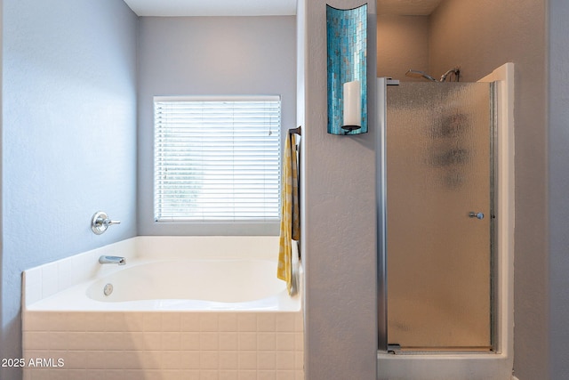 bathroom featuring a shower stall and a bath