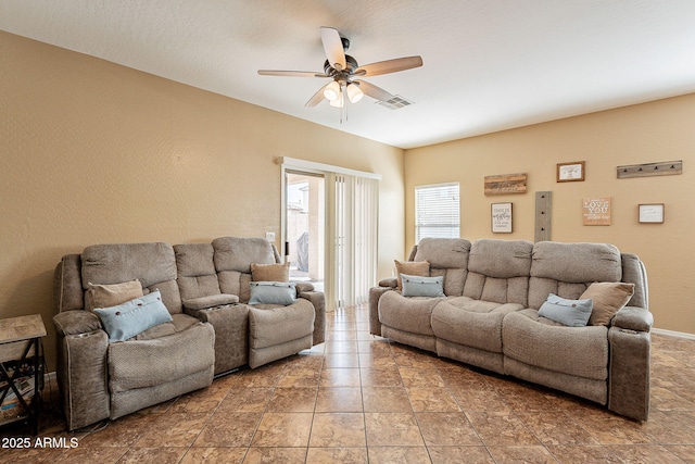 living area with visible vents and ceiling fan