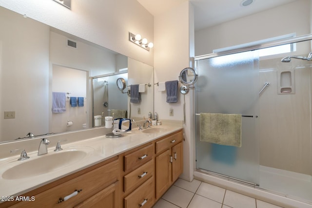 bathroom with vanity, a shower with door, and tile patterned floors