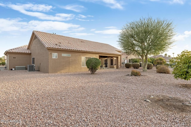 rear view of property with central AC unit