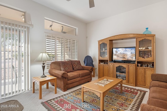 carpeted living room featuring ceiling fan