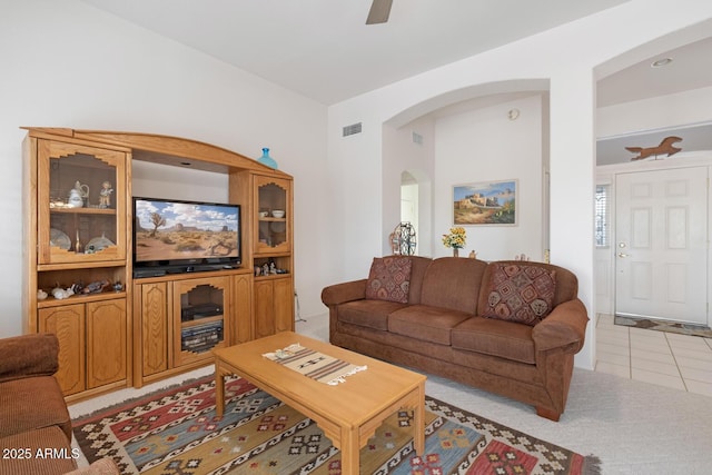 living room featuring light tile patterned floors and ceiling fan