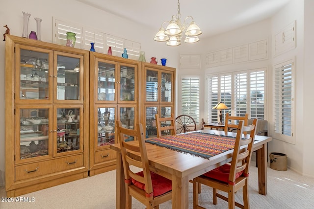 carpeted dining room with a notable chandelier