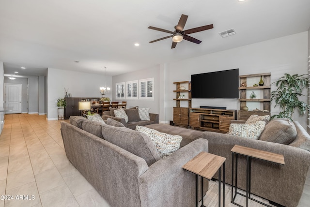 living room with ceiling fan with notable chandelier and light tile patterned flooring