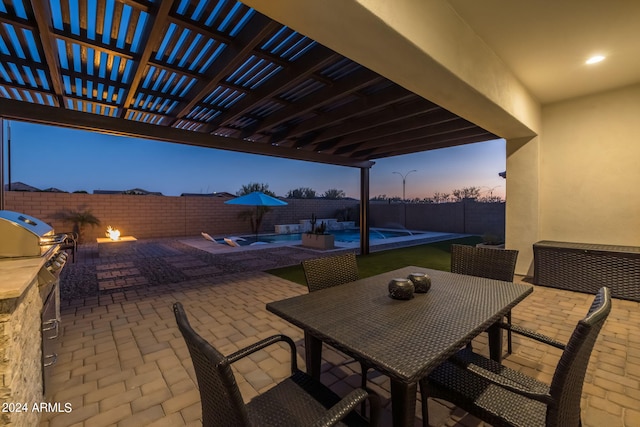 patio terrace at dusk with an outdoor kitchen, a pergola, a fenced backyard, a fenced in pool, and outdoor dining area