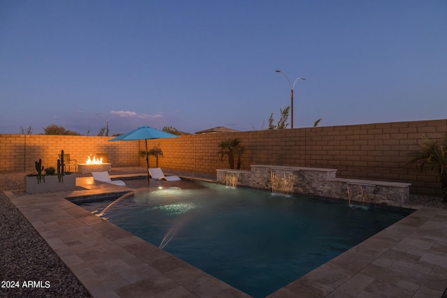 pool at dusk with pool water feature