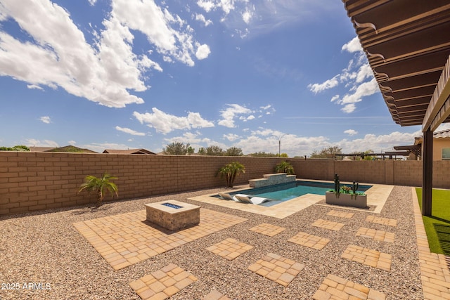 view of pool with a fenced in pool, a patio area, a fenced backyard, and an outdoor fire pit