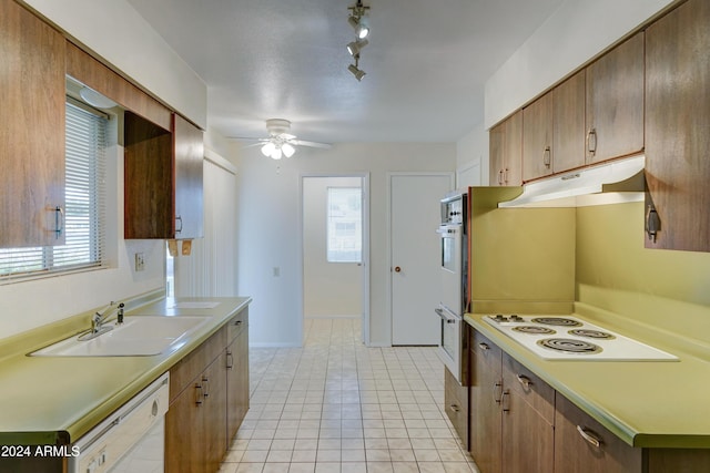 kitchen with white appliances, ceiling fan, a healthy amount of sunlight, and sink