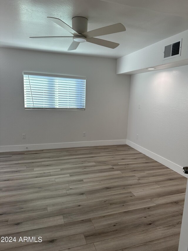 unfurnished room featuring hardwood / wood-style floors and ceiling fan