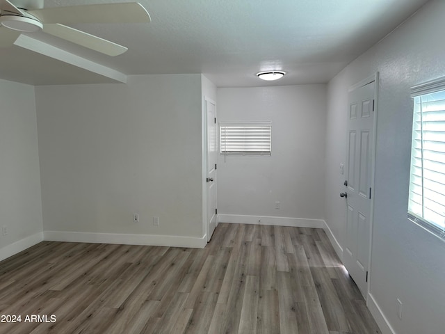 interior space featuring ceiling fan, hardwood / wood-style floors, and a wealth of natural light