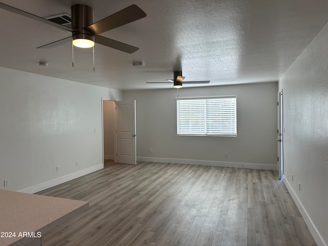 unfurnished room featuring ceiling fan and hardwood / wood-style floors