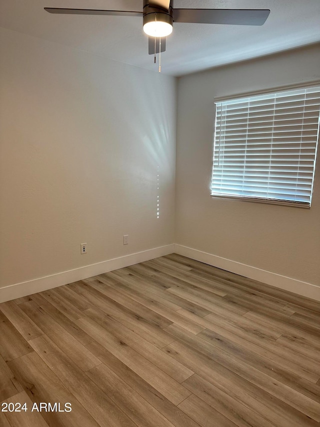 empty room with ceiling fan and wood-type flooring