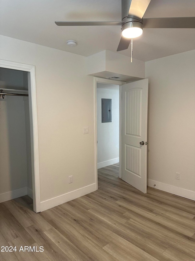 unfurnished bedroom featuring hardwood / wood-style flooring and a closet