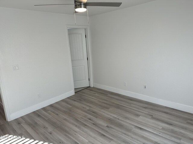 empty room featuring hardwood / wood-style flooring and ceiling fan