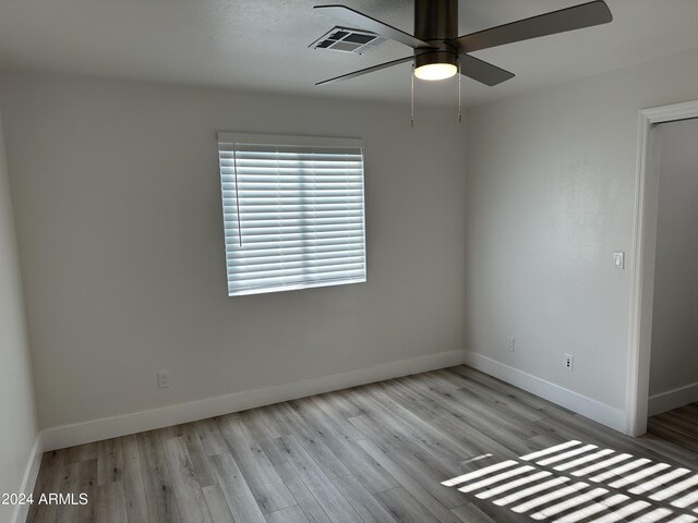 spare room featuring ceiling fan and hardwood / wood-style floors