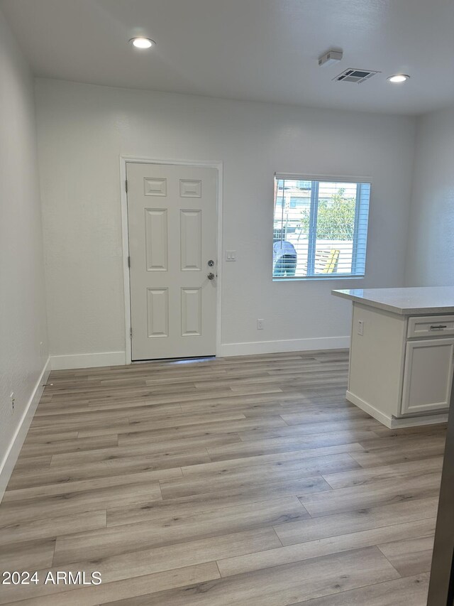 unfurnished room with light wood-type flooring