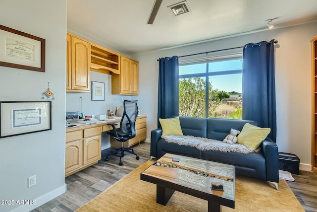 living room featuring hardwood / wood-style floors and built in desk