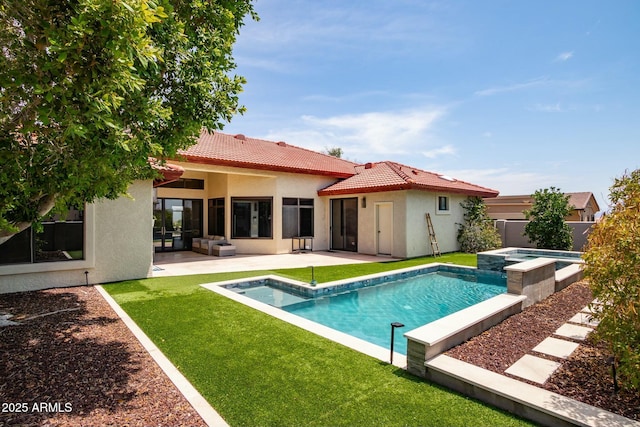 exterior space featuring an in ground hot tub, a lawn, and a patio