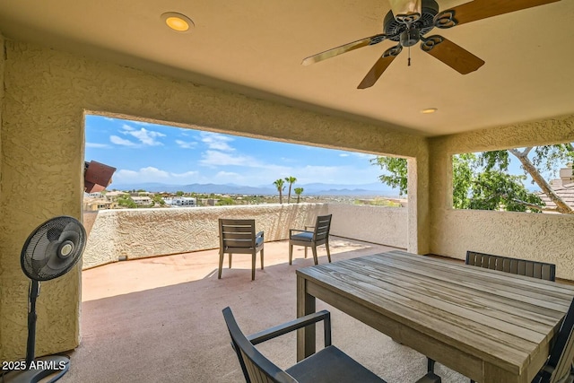 view of patio with a mountain view and ceiling fan