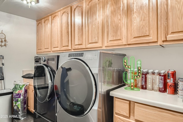 washroom featuring cabinets and separate washer and dryer