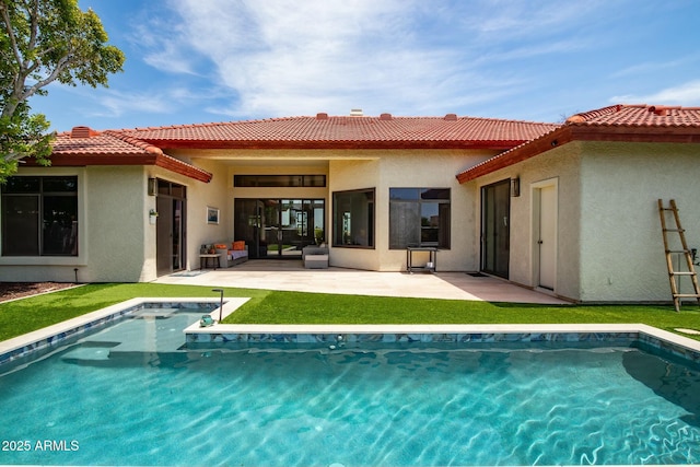 back of property featuring a patio and a yard