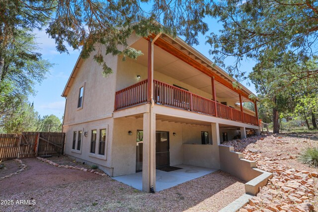 502 W Locust Rd, Payson, AZ 85541 - back of property with stucco siding, a balcony, a patio area, and a gate