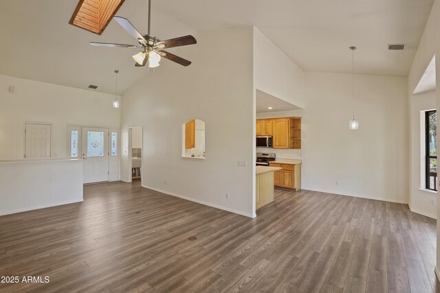 502 W Locust Rd, Payson, AZ 85541 - unfurnished living room featuring high vaulted ceiling, wood finished floors, healthy amount of natural light, ceiling fan, and baseboards