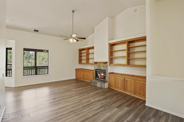 502 W Locust Rd, Payson, AZ 85541 - unfurnished living room with dark wood finished floors, a tiled fireplace, a ceiling fan, baseboards, and high vaulted ceiling