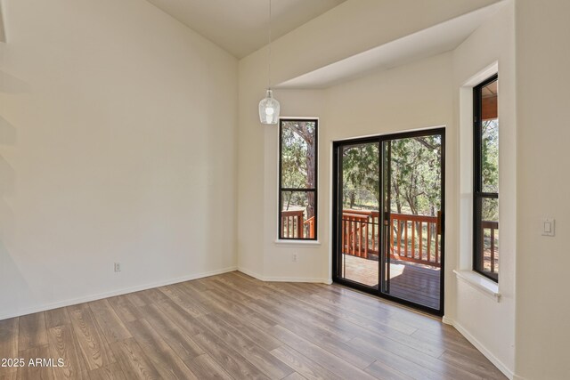 502 W Locust Rd, Payson, AZ 85541 - empty room featuring healthy amount of natural light, wood finished floors, lofted ceiling, and baseboards