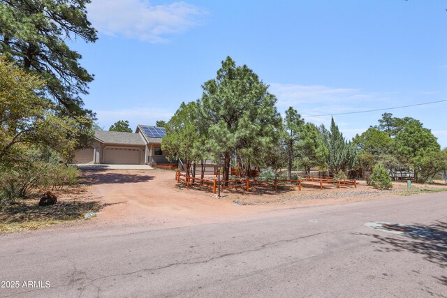 502 W Locust Rd, Payson, AZ 85541 - view of property hidden behind natural elements featuring solar panels, a garage, and driveway