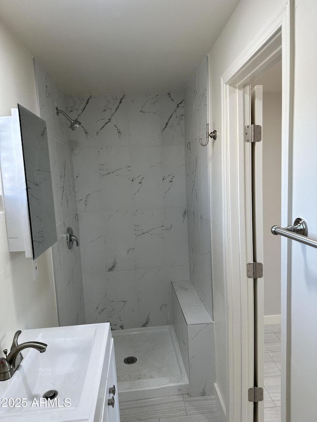 bathroom with a stall shower and vanity