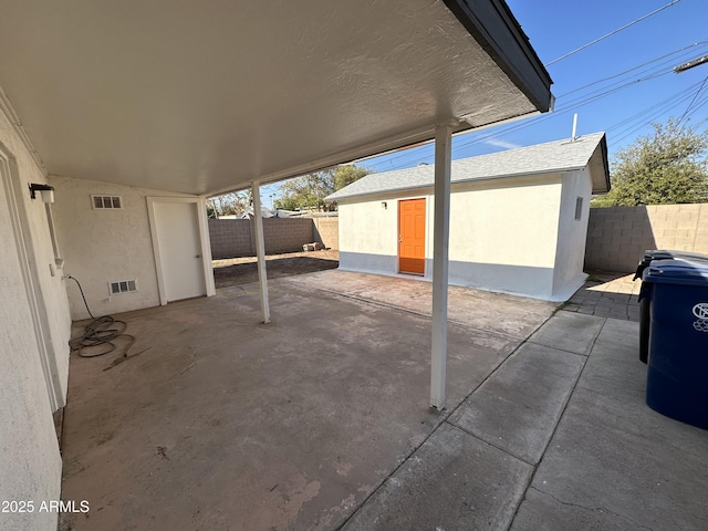 view of patio / terrace with fence and an outdoor structure