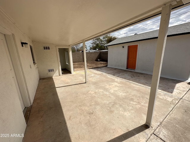 view of patio featuring fence