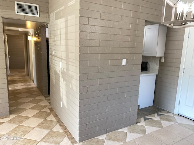 corridor with light tile patterned floors
